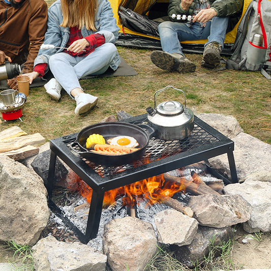 Heavy-duty steel mesh camp grill grate folded flat into its carry bag
