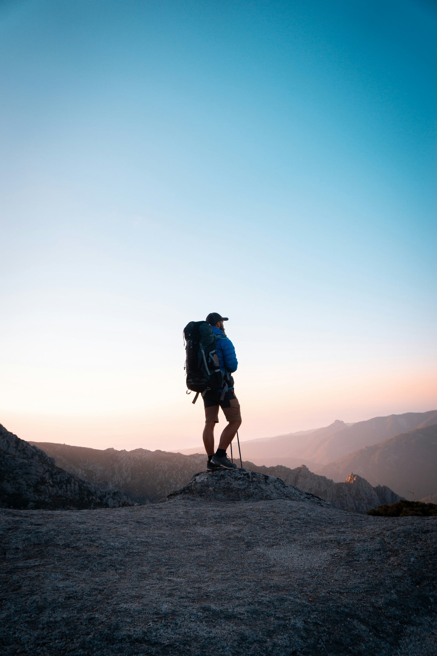 Hikers wearing backpacks walking up a trail