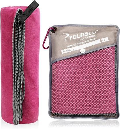 Compact travel towel clipped to a backpack with a carabiner