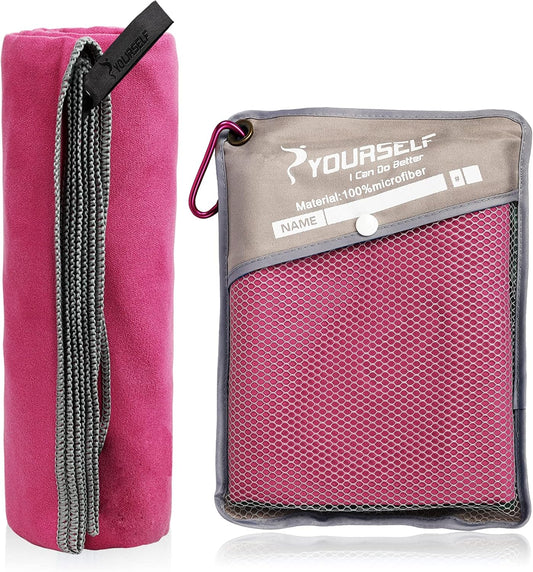 Compact travel towel clipped to a backpack with a carabiner
