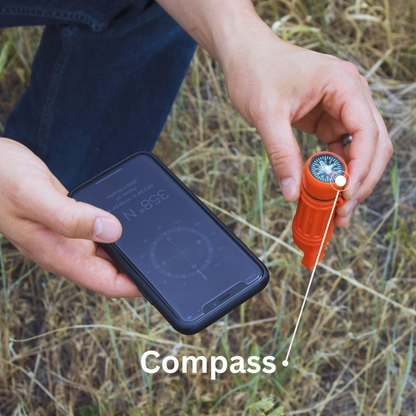 CAMPONGO™ 5-in-1 survival whistle with compass held in hand outdoors for navigation
