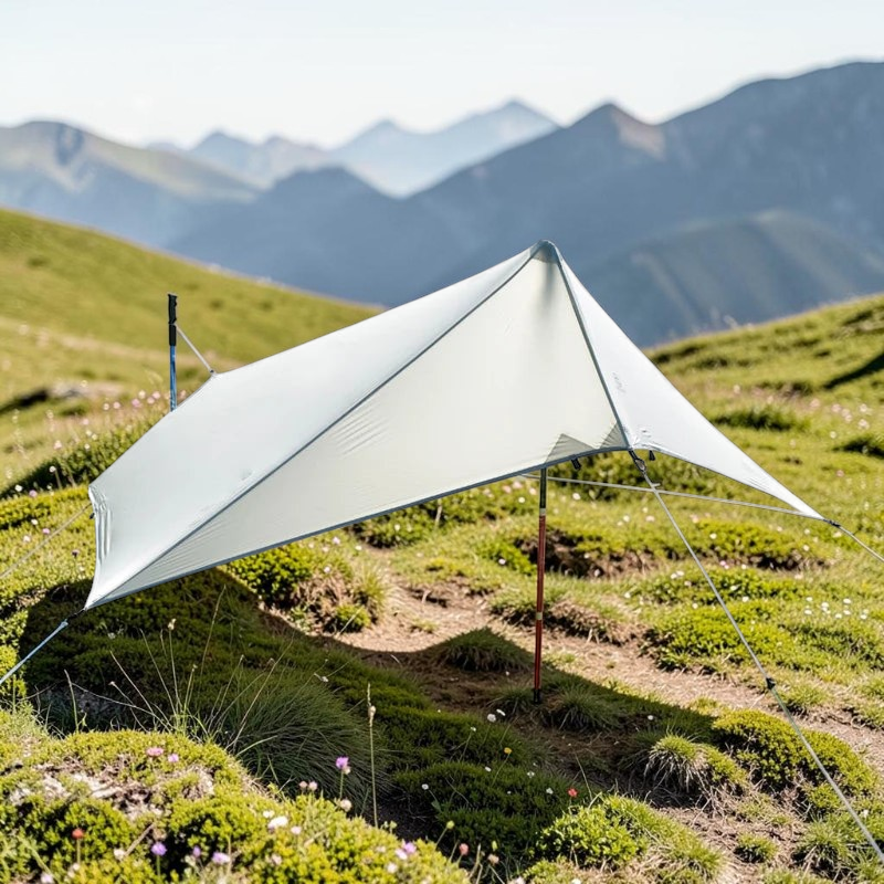 CAMPONGO™ ultralight 15D silnylon camping tarp set up as a rain fly in a scenic mountain landscape.