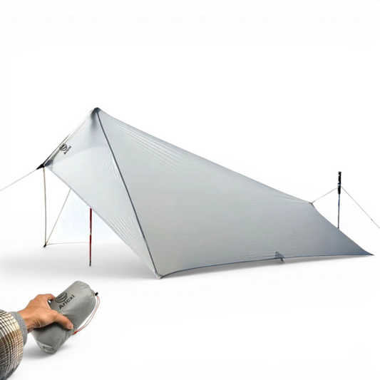 CAMPONGO™ ultralight grey 15D silnylon camping tarp set up as a rain fly with a hand holding the packed bag.